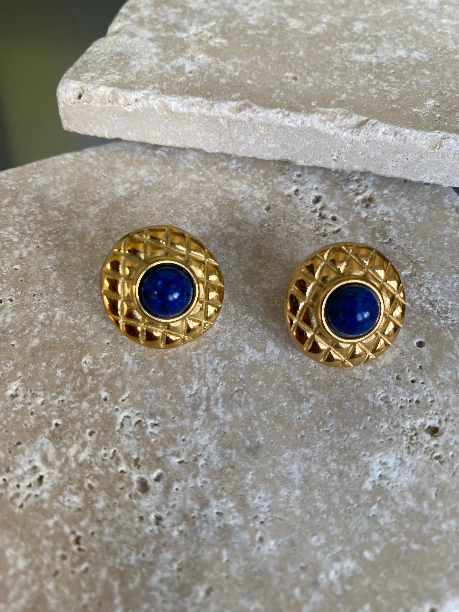 Retro style gold stud earrings with geometric detailing and dark blue accent.