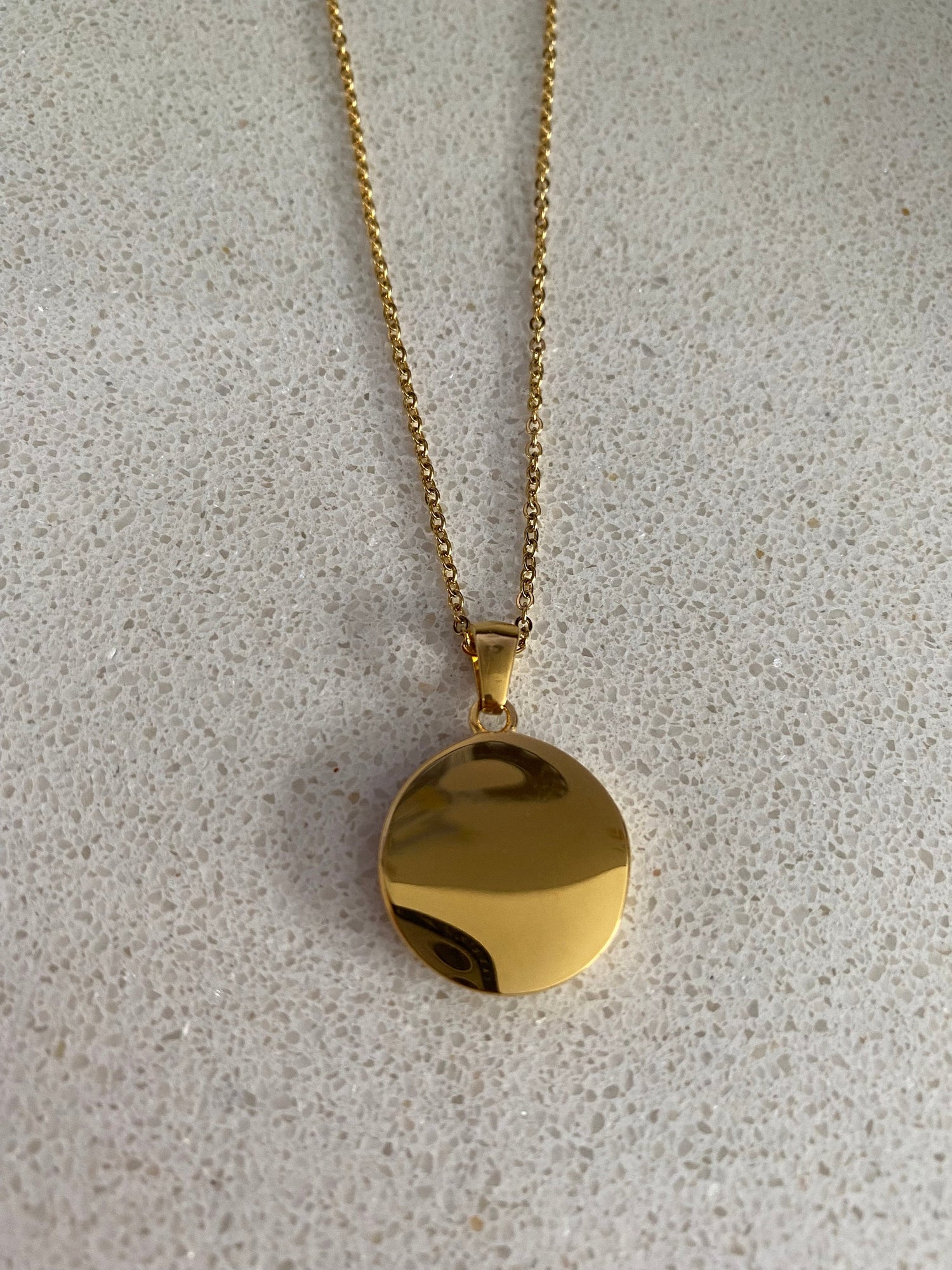 Back view of celestial coin pendant necklace with smooth gold finish