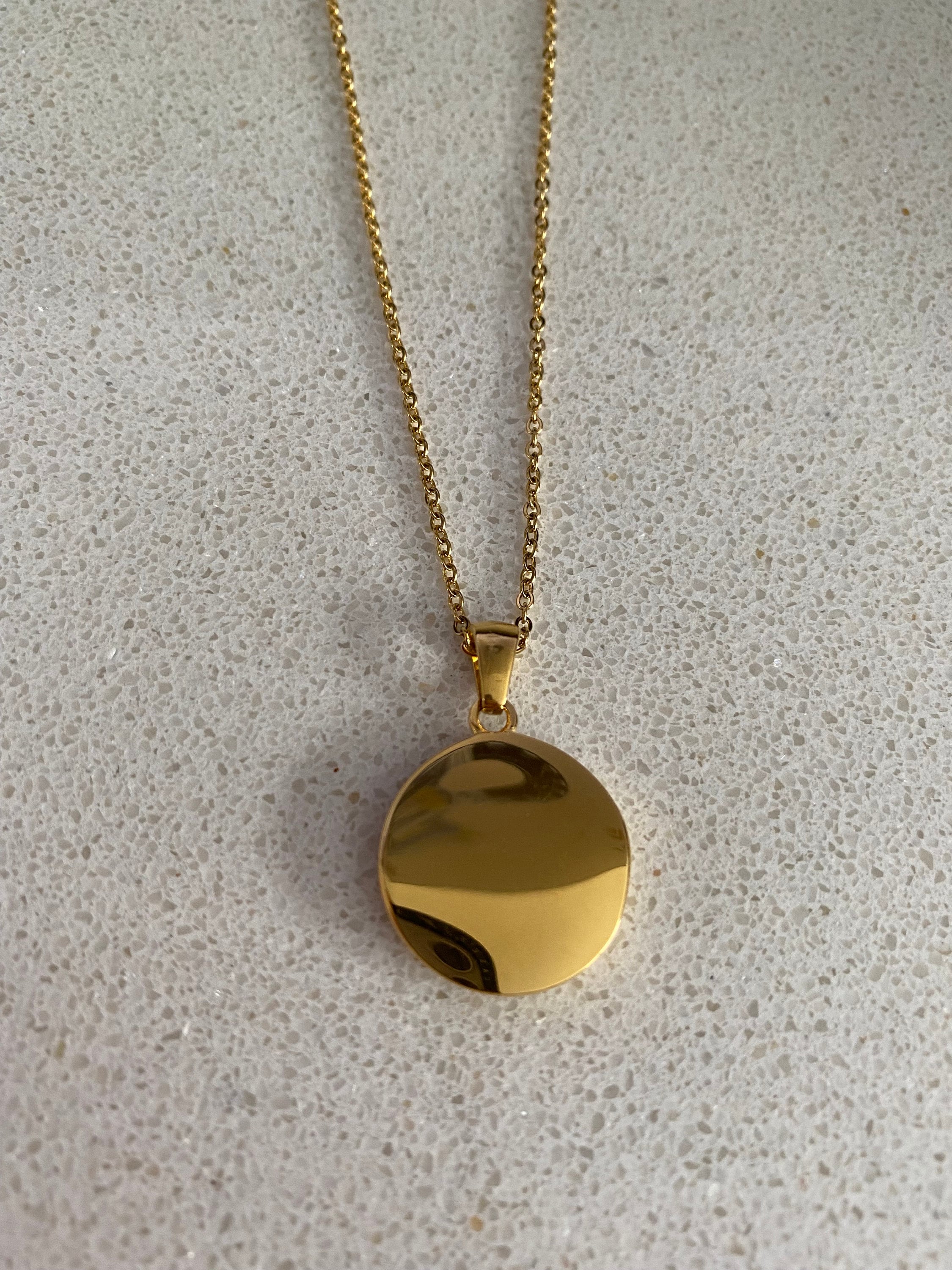Back view of celestial coin pendant necklace with smooth gold finish