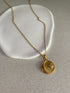 sun and moon zircon pendant necklace with gold coin design  on neutral background